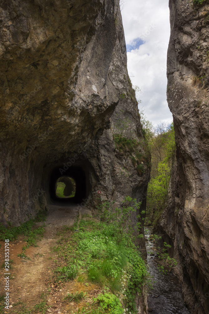 Cediljka canyon, the most narrow slot canyon in Serbia lighten by soft light and old, abandoned tunnels once used by a train to transport coal from nearby mine