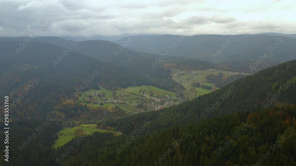 Aerial view of the village Huzenbach in Germany on a cloudy day in autumn, fall. High descend with zoom out. Aerial view of the village Huzenbach in Germany on a cloudy day in autumn, fall. High descend with zoom out.