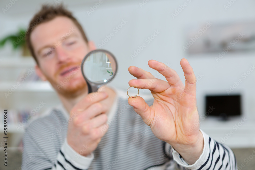 Fototapeta premium looking at a ring using magnifying glass