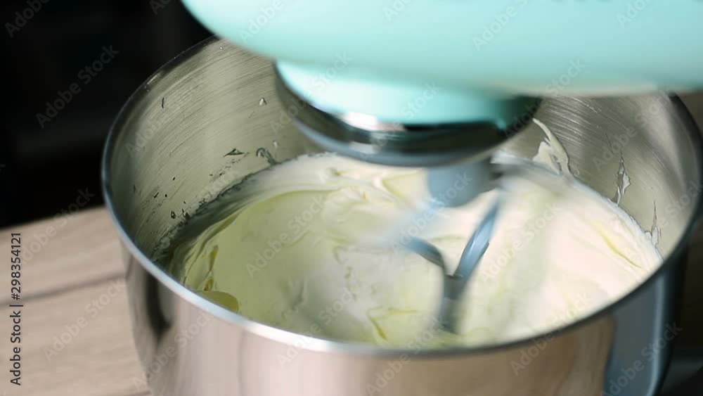 stand mixer mixing butter to make cake and cookies. Closeup view.