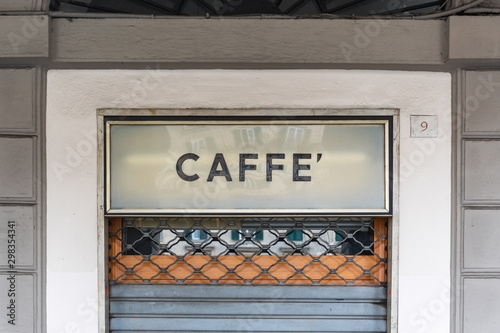 Sign "Caffe'" above a door in Italy - English translation "cafe"