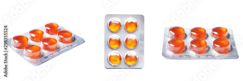 Orange Blisters with color cough drops isolated on a white background.