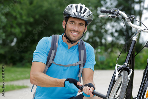 adult male in the countryside inflating bicycle tyre