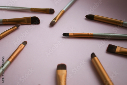 Makeup brushes on pink background