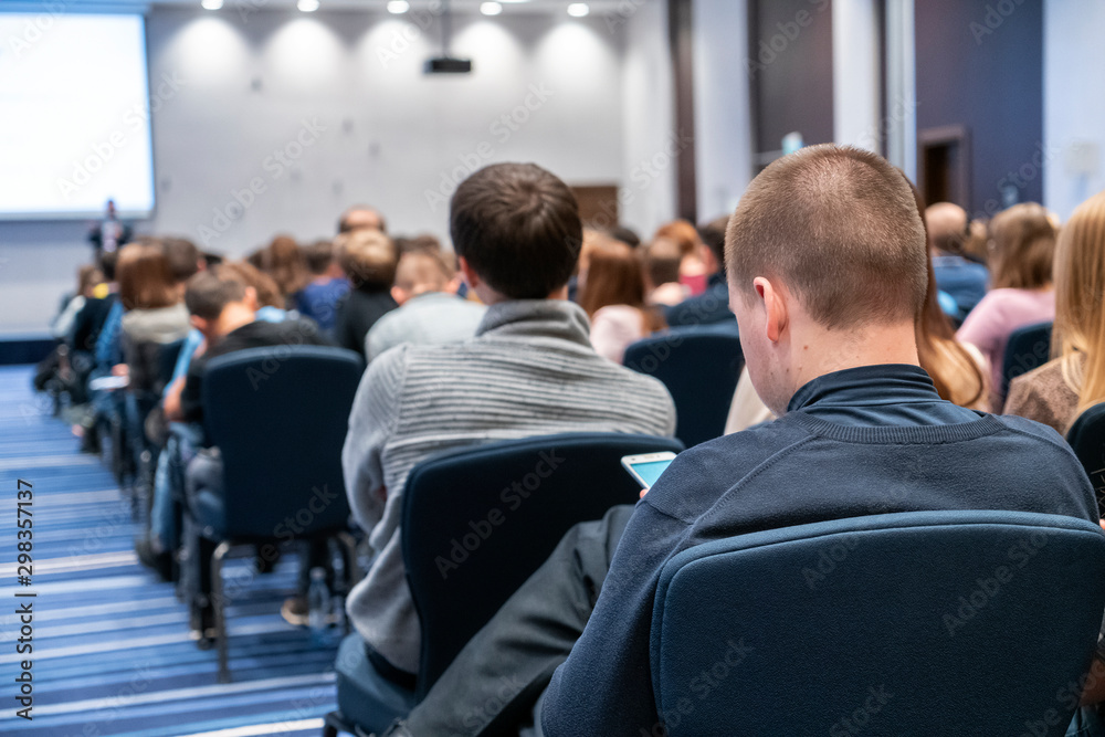 Image of a conference that takes place in a large conference room, workshop for young professionals, training in a large conference room, adult training