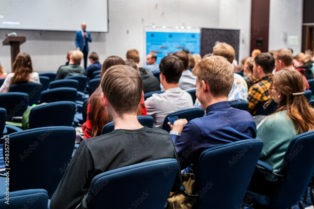 Image of a conference that takes place in a large conference room, workshop for young professionals, training in a large conference room, adult training