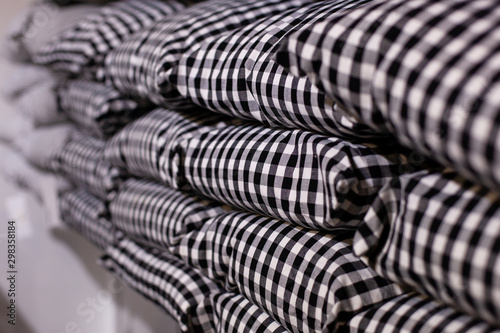 Wallpaper Mural Close-up of a stack of pillows in a black and white cage. Stack of pillows on a shelf. The store sells modern gray plaid pillows. Textiles. Home decor. cozy house. Decorative pillows isolated Torontodigital.ca