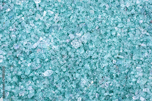 Fragments of blue glass. Small and sharp fragments of broken glass. cullet for creation of new glass are ready to be remelted. lot of particles of shattered glass. Garbage recycling. Ecology, trash photo