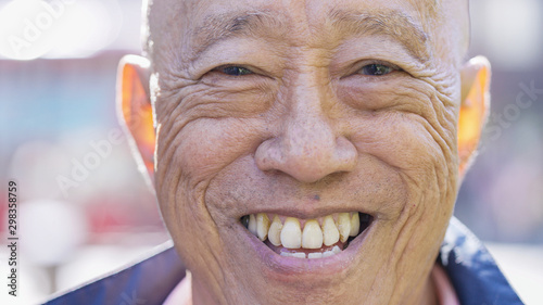 Portrait of retired senior Asian male with a big smile looking to camera 