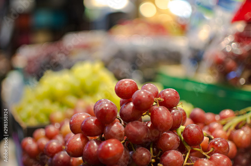 Red grapes in a grocery store with a blurry background