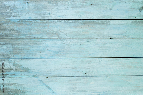 old wooden fence light blue paint peeling board texture. Background