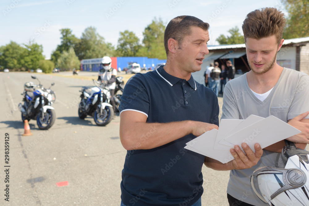 motorbike teacher showing student how to pass exam motorbike teacher showing student how to pass exam