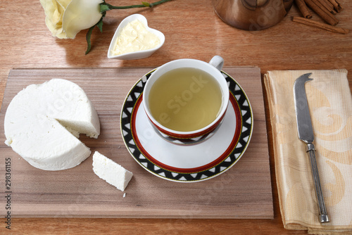 cup of tea with cheese on wooden table, brazilian breakfast