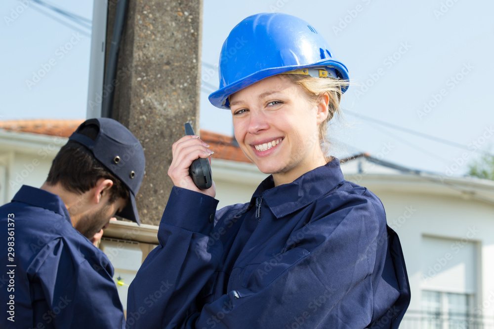 beautiful girl in a helmet using walkie talkie outdoors beautiful girl in a helmet using walkie talkie outdoors