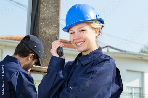 beautiful girl in a helmet using walkie talkie outdoors