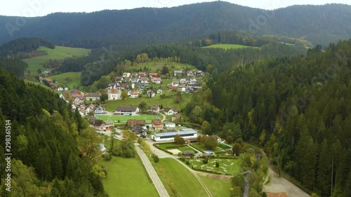 Aerial view of the village Schapbach in Germany on a cloudy day in autumn, fall. Wide view with zoom in on the town. photo