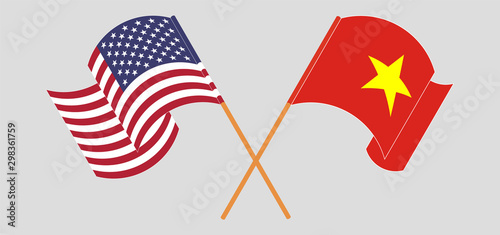 Crossed and waving flags of Vietnam and the USA