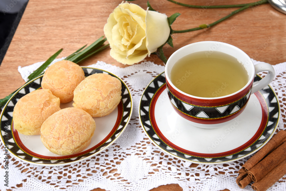 cup of tea with cheese on wooden table, brazilian breakfast cup of tea with cheese on wooden table, brazilian breakfast