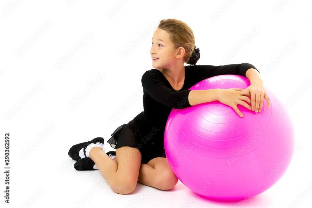 little girl doing exercises on a big ball for fitness. little girl doing exercises on a big ball for fitness.