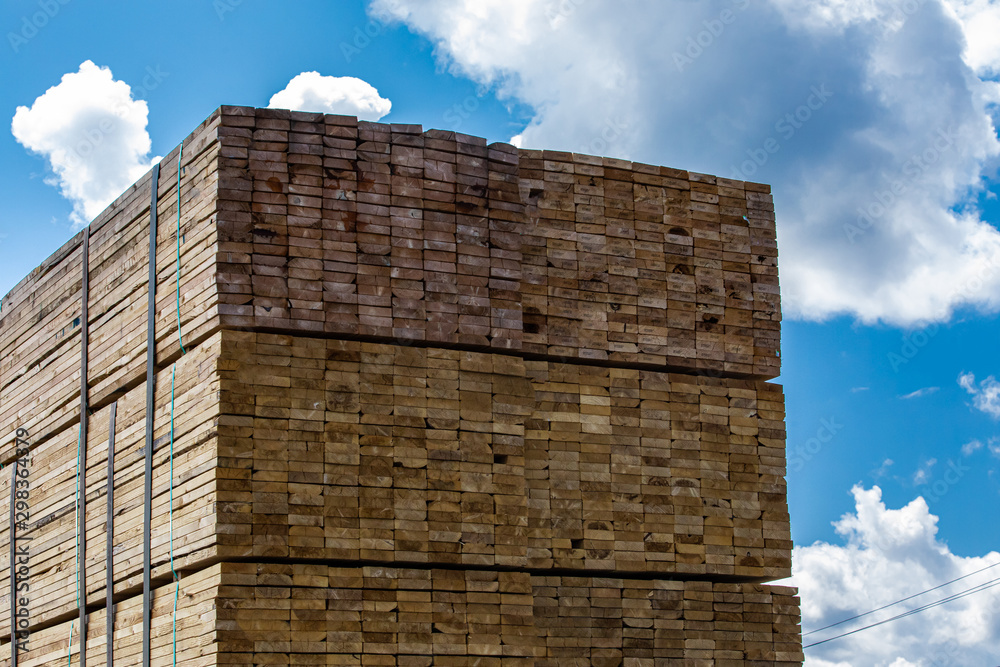 Truck is transporting a full load of canadian spruce planks to be used by carpenters. Industrial production is travelling a heavy load on the highway