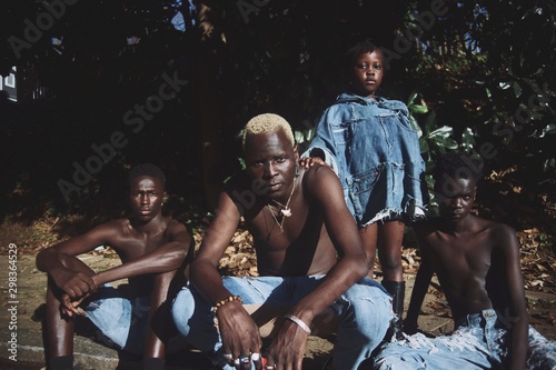 Portrait of family posing in torn jeans