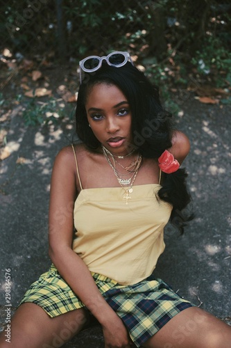 Portrait of young woman in tank top and plaid shorts