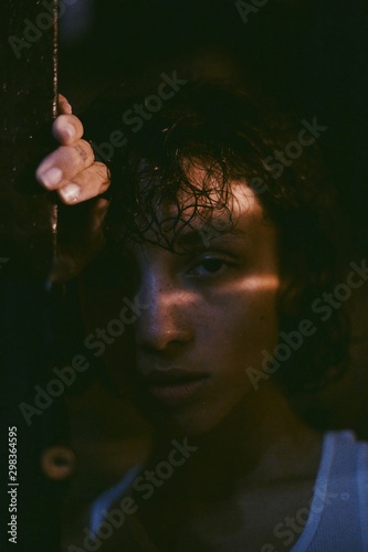 Close up of young woman in shadow and sunlight