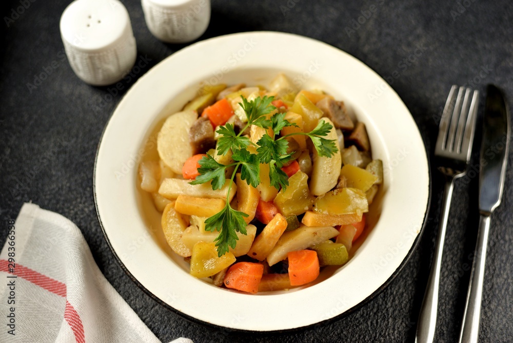 Baked potatoes, carrots, turnips, onions, eggplant and zucchini with olive oil in the oven. Wholesome, healthy homemade food.