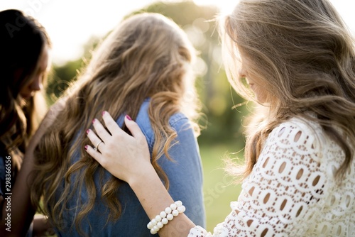 Canvas Print Closeup shot of a female blessing her friends with a blurred background
