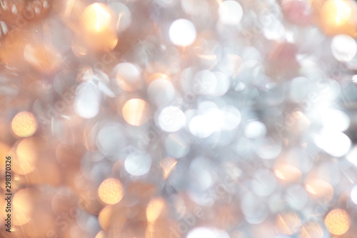 Golden christmas background and new year concept, abstract defocused light background with bokeh and blur. Winter banner for your text, background image or overlay layer in the photo editor,