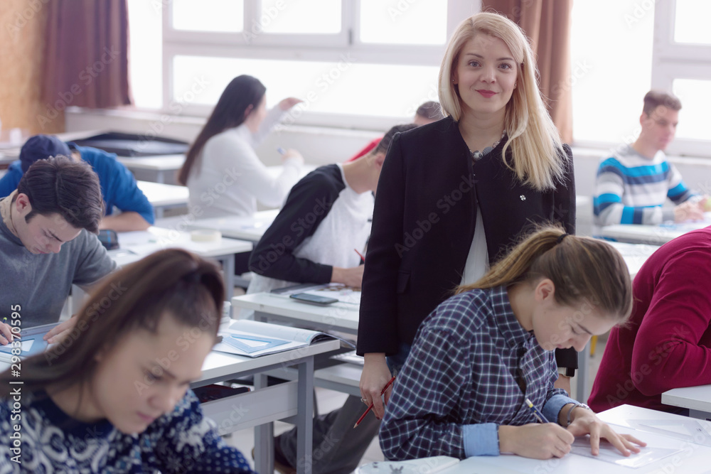 Fototapeta premium Female Architecture teacher at work. Female professor explain architectural projects to students. Beautiful female university architecture professor smiling into camera.