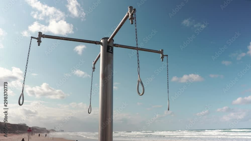Outdoor public showers by the beach. mediterranean sea and blue skies in the background. Outdoor public showers by the beach. mediterranean sea and blue skies in the background.