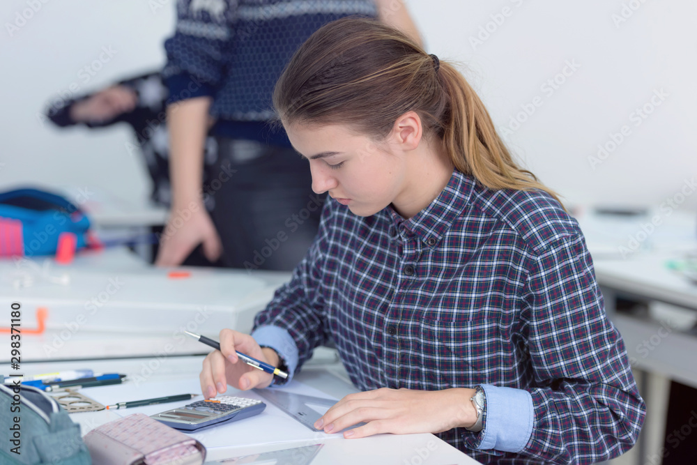 Female university architecture student working on practice lessons. Looking for solution during class.