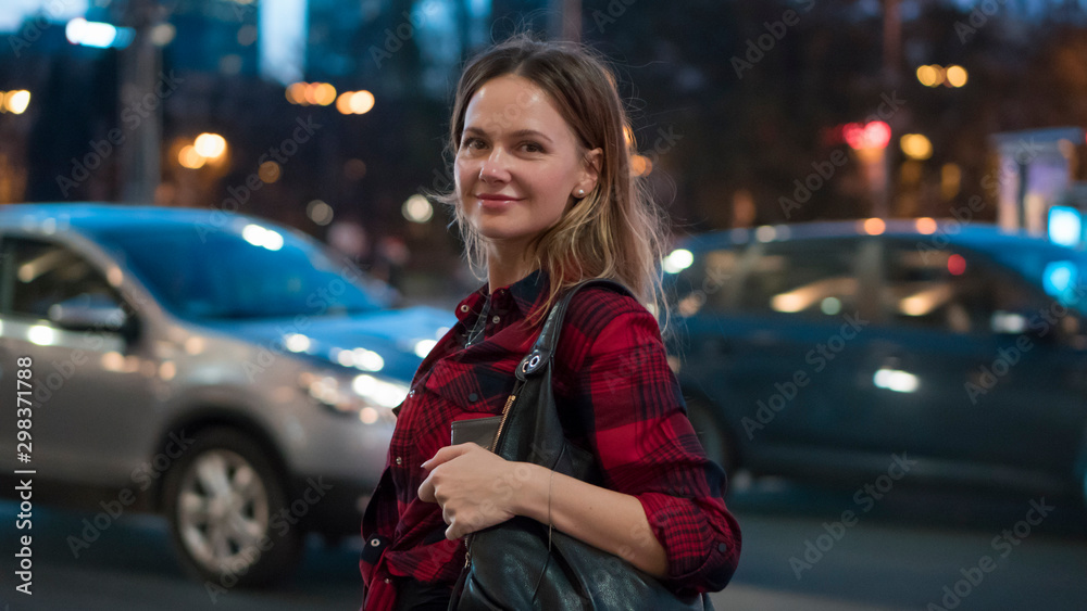 Tourism concept. Young woman with beautiful hair  walking by the city.