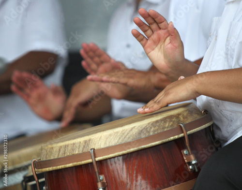 Hands playing puerto rican folk music in a typical latin drums photo