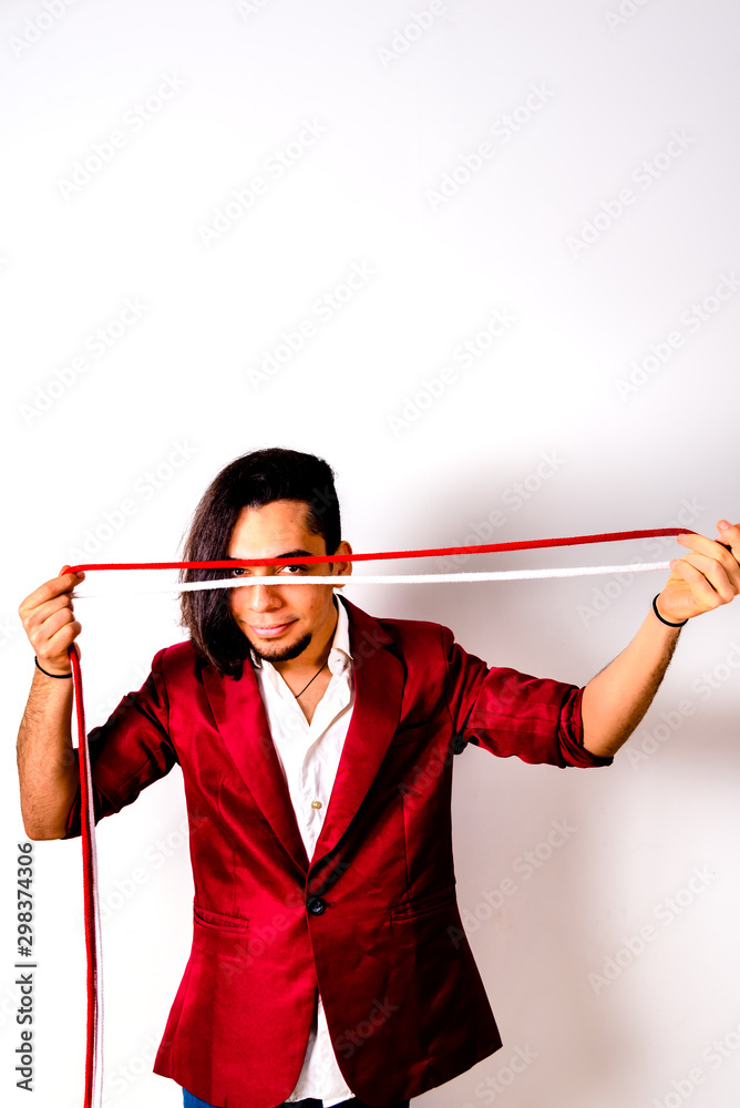 Portrait of young magician handling ropes and bandanas to do magic tricks, isolated on white. Portrait of young magician handling ropes and bandanas to do magic tricks, isolated on white.