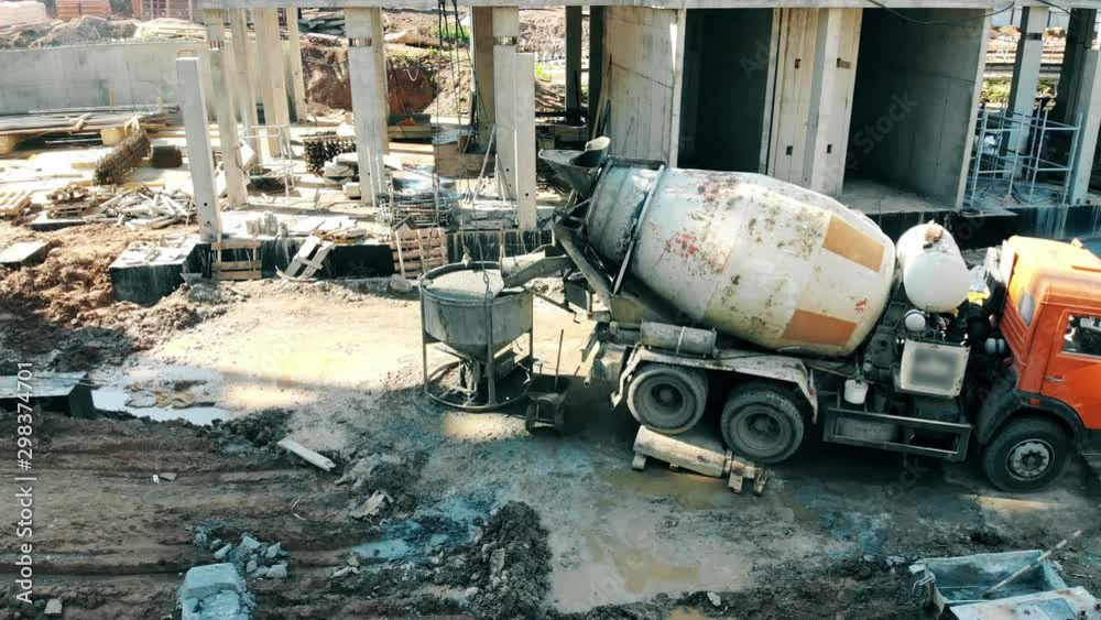 Project site with an industrial machine mixing concrete Project site with an industrial machine mixing concrete