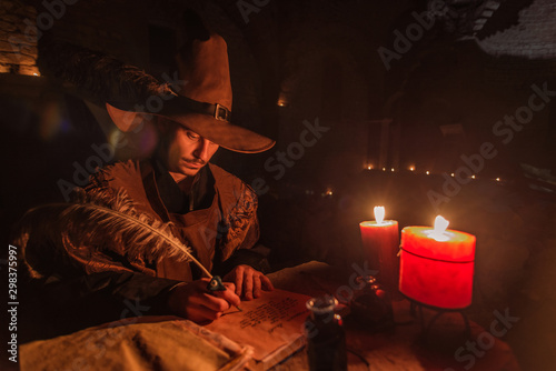 Nostradamus writing his prophesies, fantasy concept. illuminated by candles, long exposure, motion blur, high ISO