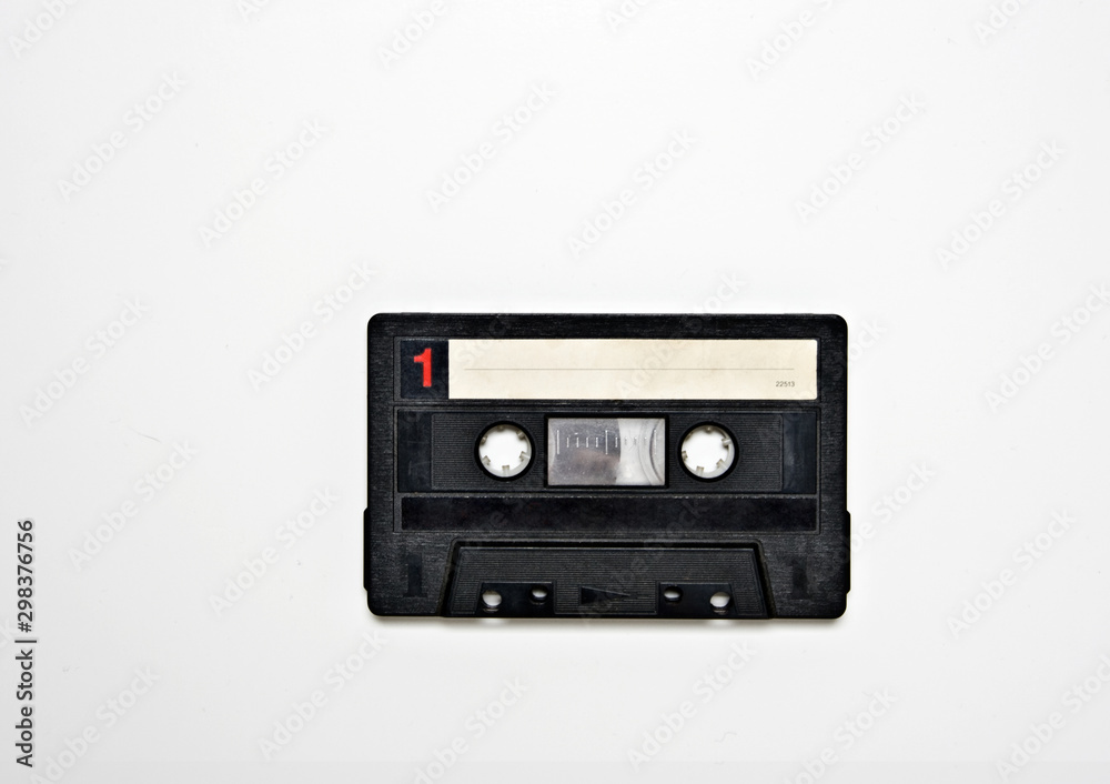 Black, white and red audio cassette tape on a white background. 