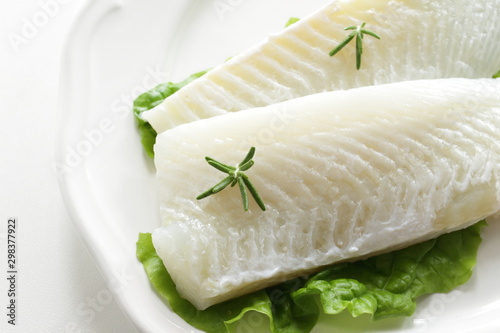Freshness flat fish fillet on dish with rosemary