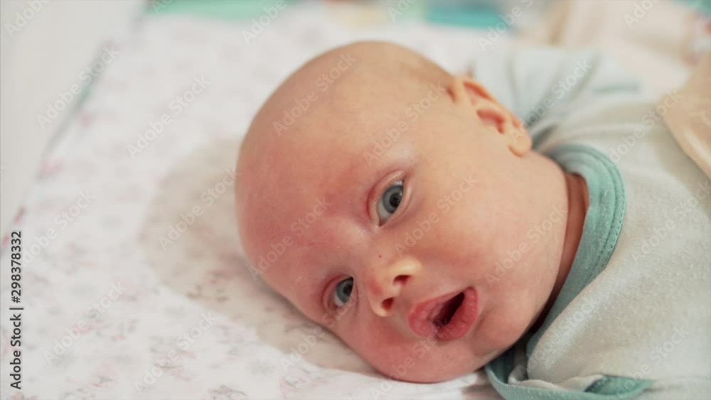 Close portrait of cute newborn boy laying in his bed Close portrait of cute newborn boy laying in his bed