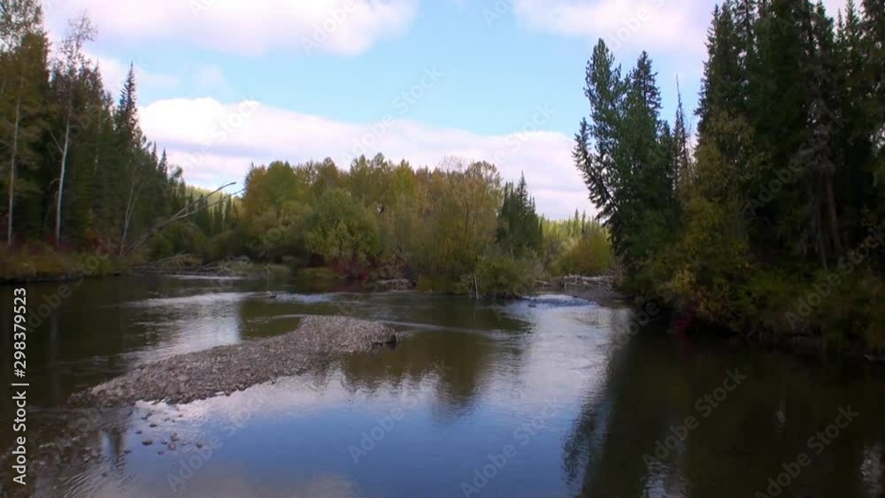 Shooting from moving motorboat of dangerous rapids with clear transparent water of Lena River on background of trees on banks in Siberia. Shooting from moving motorboat of dangerous rapids with clear transparent water of Lena River on background of trees on banks in Siberia.