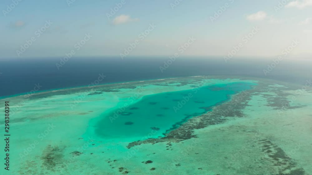 Tropical coral atoll with turquoise water against the sky with clouds top view. Summer and travel vacation concept. Balabac, Palawan, Philippines Tropical coral atoll with turquoise water against the sky with clouds top view. Summer and travel vacation concept. Balabac, Palawan, Philippines