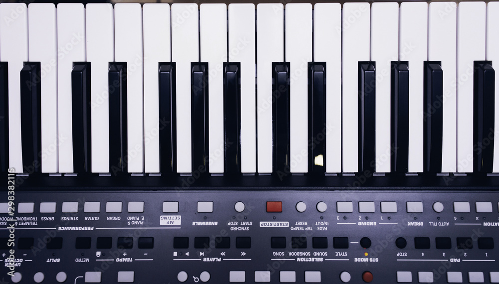 piano or electronic synthesizer (piano keyboard) background Midi keyboard and controller with faders and buttons. Concept of close texture pattern music design banner piano or electronic synthesizer (piano keyboard) background Midi keyboard and controller with faders and buttons. Concept of close texture pattern music design banner