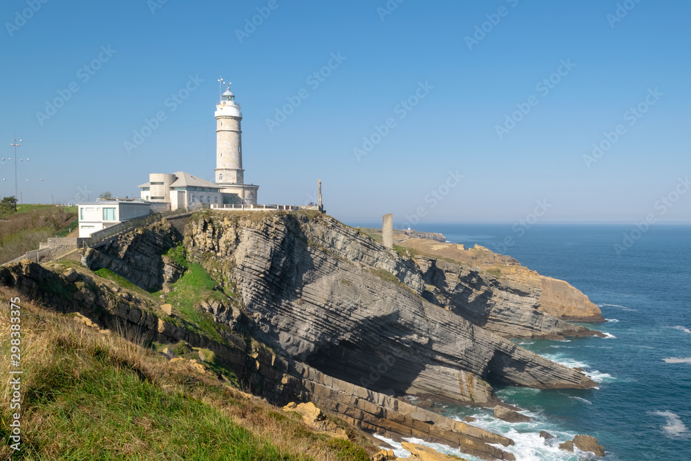 Lighthouse of Cabo Mayor in Santander. Lighthouse on the cliff with the sea under.