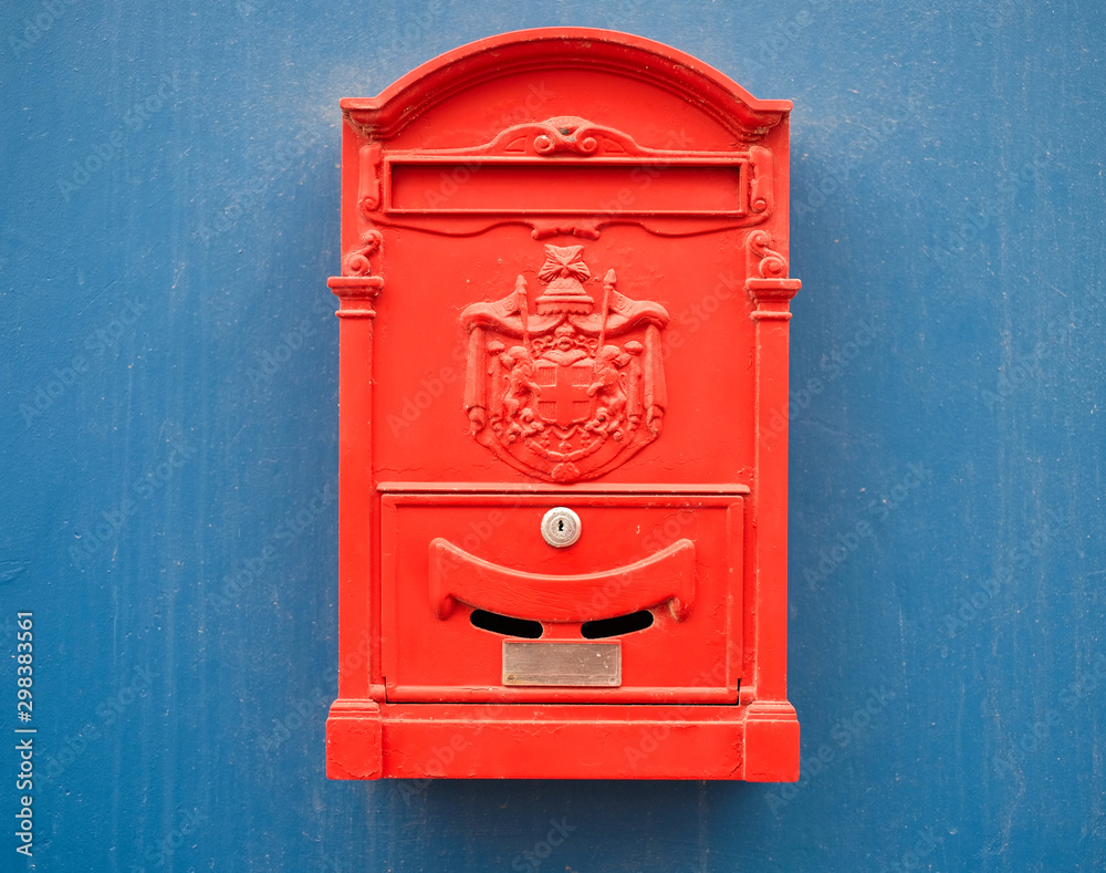 Bright red mail box on a blue background.