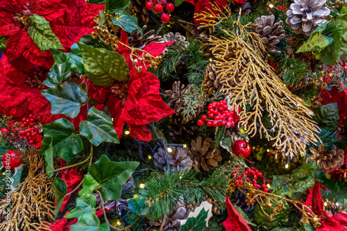 Xmas decorations. Сollage of flower petals, berries, apples, Golden branches, cones, garlands, and Christmas tree branches. Close-up. Xmas