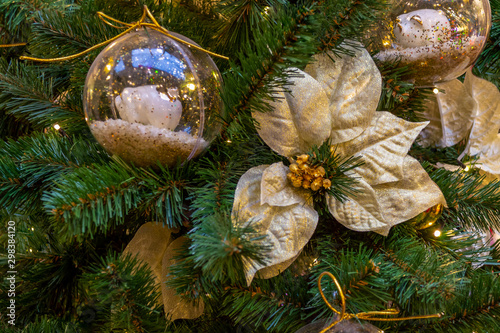 Christmas decorations. A gold flower hangs on a branch. Macro. Close-up. Xmas