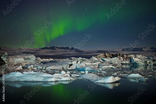 Aurora borealis above icebergse in the Jokulsarlon glacier lagoon, Iceland. photo