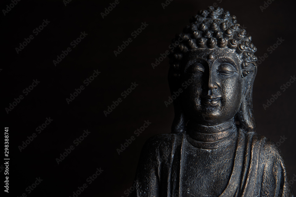 Buddha sculpture on black background